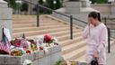 Leah Palmer visits a makeshift memorial for Minnesota state Rep. Melissa Hortman and her husband Mark in St. Paul.
