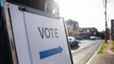 A sign showing people where they should cast their ballots for an election. A sign showing people where they should cast their ballots for an election.