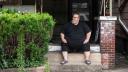 Mike Ramsey sits on the front porch of his house. Mike Ramsey sits on the front porch of his house.