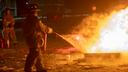 A firefighter puts out a fire during a training class. A firefighter puts out a fire during a training class.