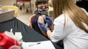 A child receives a vaccine from a nurse A child receives a vaccine from a nurse
