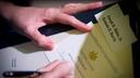 A voter fills out a ballot