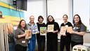 A Book a Day staffers and affiliates pose with hospital workers at Thomas Jefferson University Hospital, celebrating the launch of a new program last December.