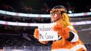 Philadelphia Flyers mascot Gritty welcoming Gov. Tom Wolf to a press conference in 2021.