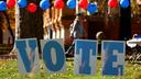 Students on the campus of the University of Pittsburgh walk past a ‘vote’ sign on Election Day, Nov. 5., 2024.
