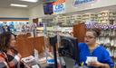 Customer Lisa Durs is helped by pharmacy clerk Kira Tomoney at Minnich's Pharmacy in York County.