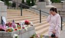 Leah Palmer visits a makeshift memorial for Minnesota state Rep. Melissa Hortman and her husband Mark in St. Paul.