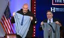 Democratic Sen. John Fetterman (left) and Republican Sen. Dave McCormick of Pennsylvania display hoodies presented by the Edward M. Kennedy Institute for the United States Senate after participating in a debate Monday, June 2, 2025 in Boston.