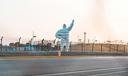 The “Michelin Man” positioned near a racetrack.