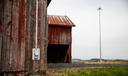 Red barn in rural Pennsylvania with a cellular tower in the background