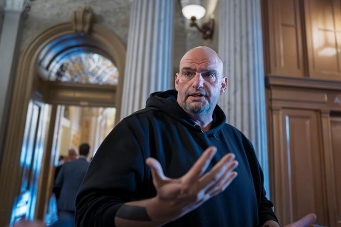 Sen. John Fetterman, D-Pa., talks to reporters outside the chamber during a vote at the Capitol in Washington, March 13, 2025.