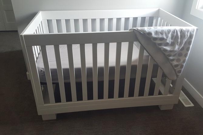 A crib in a room. A crib in a room.
