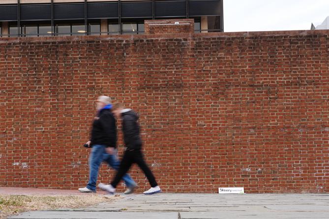 People walk past locations of the now removed explanatory panels that were part of an exhibit on slavery at President's House Site in Philadelphia.