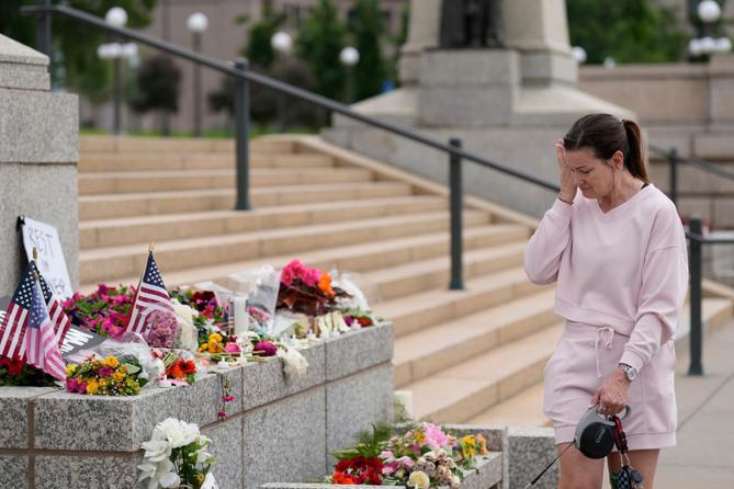 Leah Palmer visits a makeshift memorial for Minnesota state Rep. Melissa Hortman and her husband Mark in St. Paul.