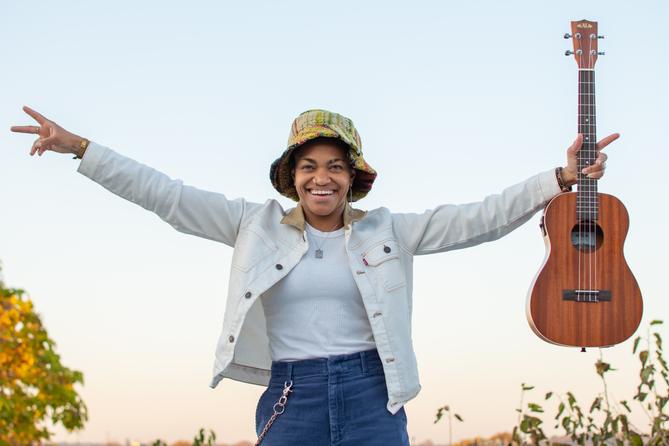 Country musician Sug Daniels poses with a guitar.