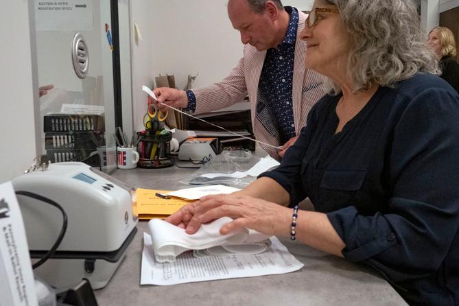 Snyder County Election Director Devin Rhoads reviews the results of a precinct’s return as election worker Stacy Guyer collects election materials. Snyder County Election Director Devin Rhoads reviews the results of a precinct’s return as election worker Stacy Guyer collects election materials.