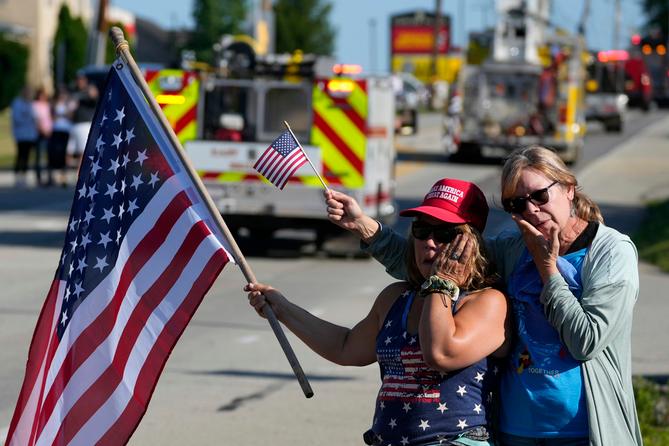 Merri Cambo of Saxonburg, Pa., and her friend, Jane Wesolosky, of Buffalo, Pa., react as the funeral procession for Corey Comperatore passes by July 19 in Sarver, Pennsylvania. Merri Cambo of Saxonburg, Pa., and her friend, Jane Wesolosky, of Buffalo, Pa., react as the funeral procession for Corey Comperatore passes by July 19 in Sarver, Pennsylvania.