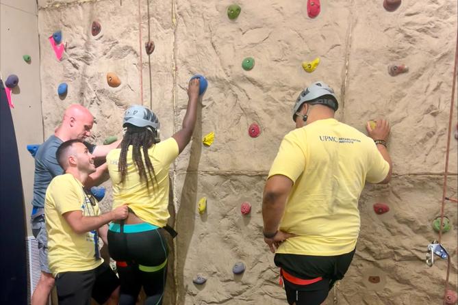 Campers prepare to mount a rock climbing wall. Campers prepare to mount a rock climbing wall.