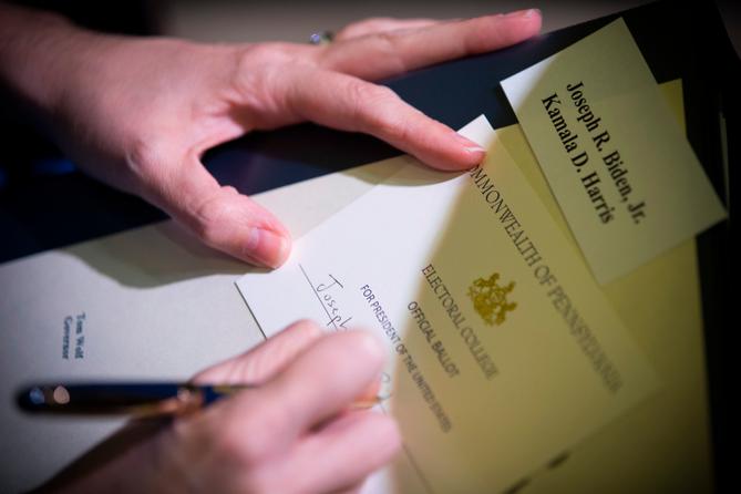 A voter fills out a ballot