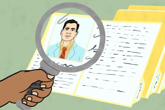 A person holds a magnifying glass up to a picture of a doctor, as part of that doctor's file. A person holds a magnifying glass up to a picture of a doctor, as part of that doctor's file.