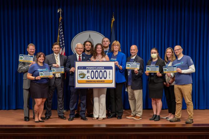 Attendees pose at a 2024 Harrisburg event celebrating a license plate featuring the state amphibian. Attendees pose at a 2024 Harrisburg event celebrating a license plate featuring the state amphibian.