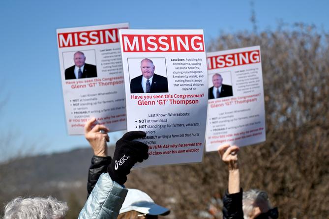 People hold up signs of U.S. Rep. Glenn Thompson that say “missing” during a protest outside his Bellefonte office. People hold up signs of U.S. Rep. Glenn Thompson that say “missing” during a protest outside his Bellefonte office.