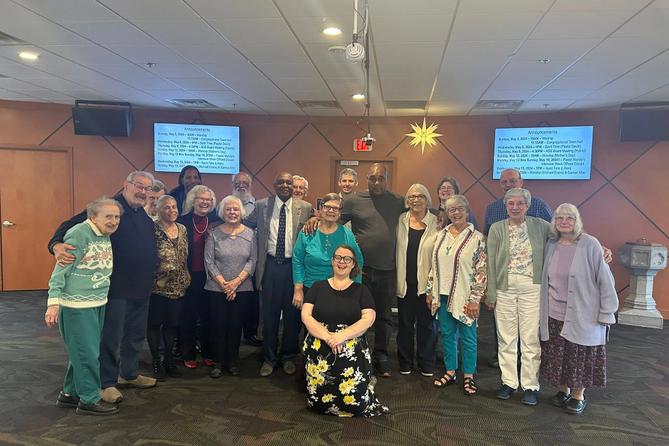 Mandy Mastros (center) surrounded by a group of Lancaster Moravian Church congregants. Mandy Mastros (center) surrounded by a group of Lancaster Moravian Church congregants.