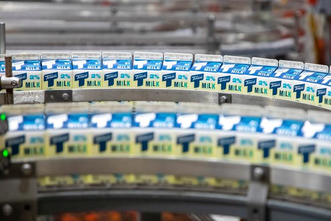 Milk cartons on a production line. Milk cartons on a production line.