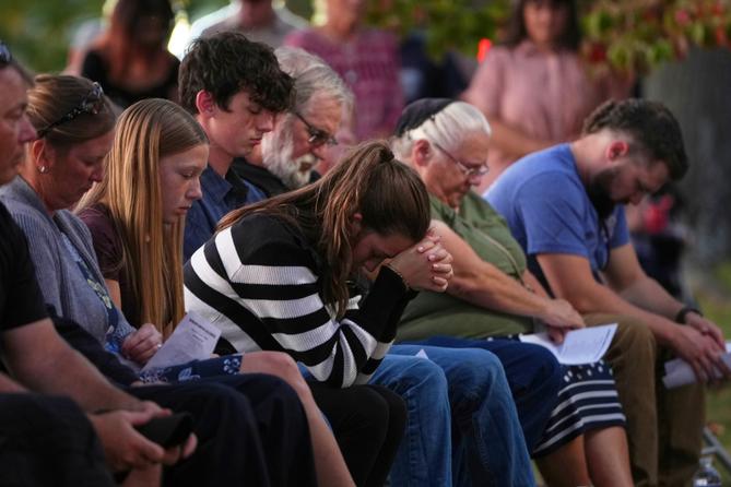 Attendees react during a vigil in Spring Grove, PA, after multiple police officers were shot and killed. Attendees react during a vigil in Spring Grove, PA, after multiple police officers were shot and killed.