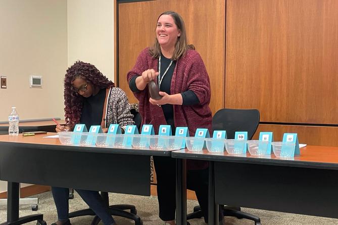 Christa Miller, Lancaster County’s election director, shakes a bottle filled with red, numbered marbles to determine the winner of tied races.