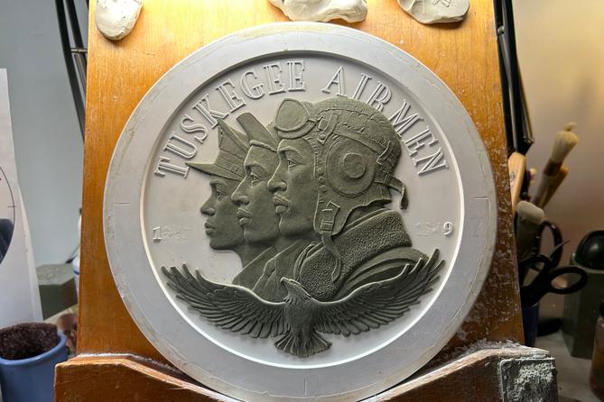 A clay and plaster sculpture in relief of the Tuskegee Airmen by U.S. Mint medallic artist Phebe Hemphill for a Congressional Gold Medal.