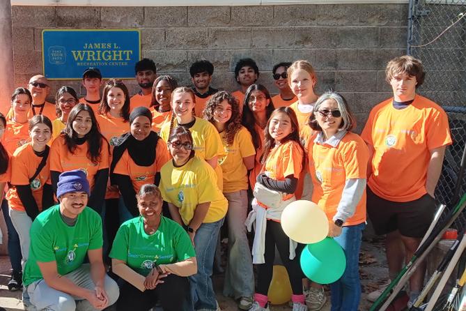 Gweny Love poses with volunteers from a neighborhood cleanup