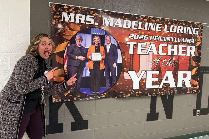 Madeline Loring poses with a sign celebrating her Teacher of The Year Award. Madeline Loring poses with a sign celebrating her Teacher of The Year Award.