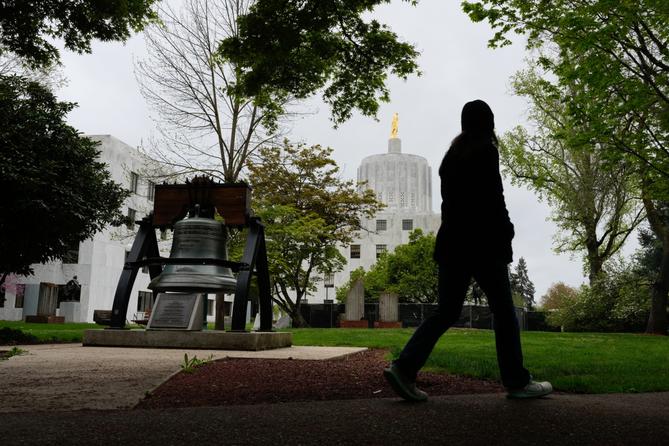 A person walks by a Liberty Bell replica at the Oregon state Capitol on Tuesday, April 14, 2026, in Salem, Ore. A person walks by a Liberty Bell replica at the Oregon state Capitol on Tuesday, April 14, 2026, in Salem, Ore.