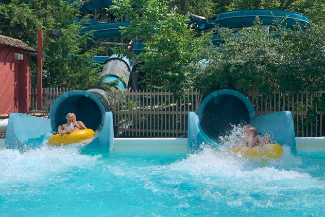Knoebels patrons plunge into a pool from a water slide