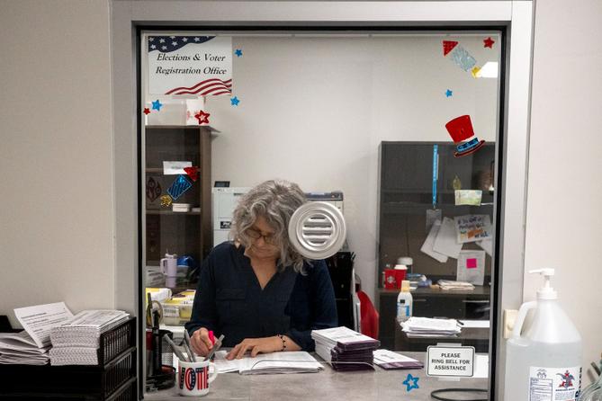 Stacy Guyer uses a pink highlighter to mark off the names corresponding to the mail ballot request list as she verifies the ballots that have been scanned in. Stacy Guyer uses a pink highlighter to mark off the names corresponding to the mail ballot request list as she verifies the ballots that have been scanned in.