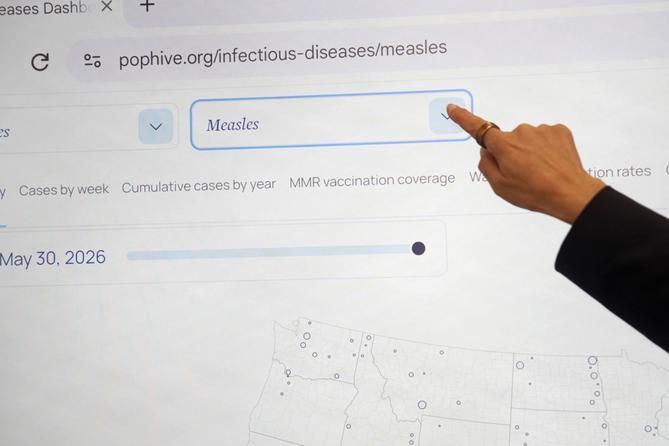 Georgetown University's Rebecca Katz points to measles data for the country at Georgetown's Health Security Operations Center in Washington on June 3, 2026.