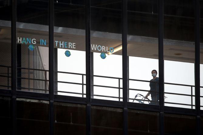 A sign that reads "HANG IN THERE WORLD" is seen in the windows of the enclosed walkway at Thomas Jefferson University Hospital in Philadelphia. State officials are asking hospitals to work together as some face a staffing crisis. A sign that reads "HANG IN THERE WORLD" is seen in the windows of the enclosed walkway at Thomas Jefferson University Hospital in Philadelphia. State officials are asking hospitals to work together as some face a staffing crisis.