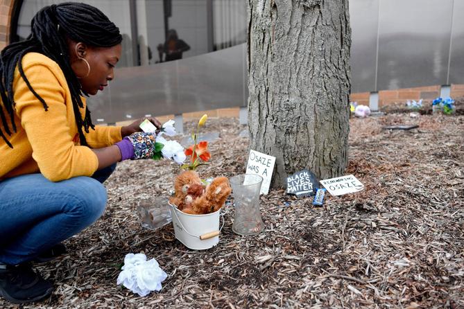 A woman cleans up the Black Lives Matter memorial at the Dr. Martin Luther King Jr. Plaza in downtown State College. A woman cleans up the Black Lives Matter memorial at the Dr. Martin Luther King Jr. Plaza in downtown State College.