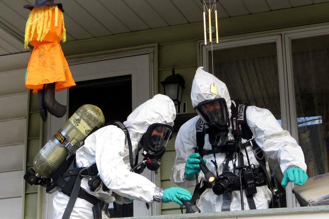 Members of the Pennsylvania State Police Clandestine Lab Response Team remove chemicals from the front porch of a home in Minersville in 2013. Members of the Pennsylvania State Police Clandestine Lab Response Team remove chemicals from the front porch of a home in Minersville in 2013.