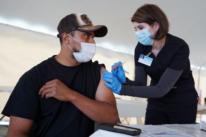 Giorgi Mushroom Company worker Juan Frutos gets a vaccine shot from Penn State Health nurse Christy Daniels during a clinic facilitated by Latino Connection's mobile unit. The Wolf administration hired the group this spring to address persistent disparities. Giorgi Mushroom Company worker Juan Frutos gets a vaccine shot from Penn State Health nurse Christy Daniels during a clinic facilitated by Latino Connection's mobile unit. The Wolf administration hired the group this spring to address persistent disparities.