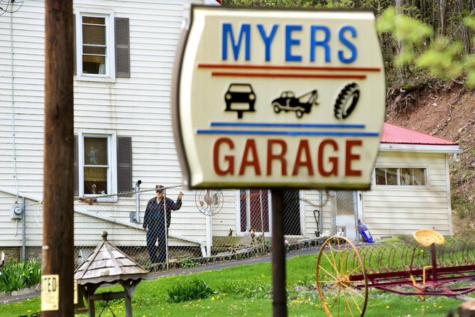 John Myers, whose son shot at BLM activists in August, stands outside his home and garage.