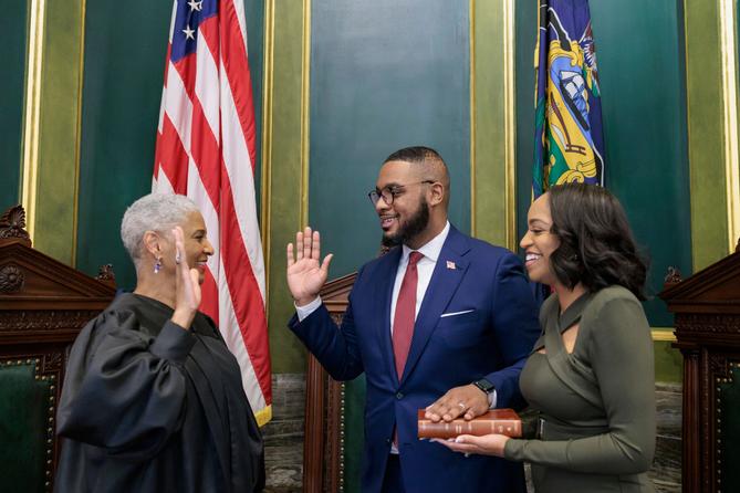Austin Davis (center) is sworn in as lieutenant governor flanked by his wife Blayre Holmes Davis (right). Austin Davis (center) is sworn in as lieutenant governor flanked by his wife Blayre Holmes Davis (right).