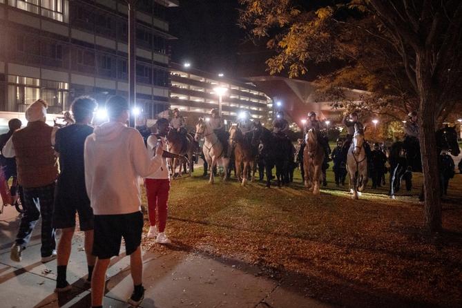 Pennsylvania State Police on horseback try to control a crowd on Penn State's campus. Pennsylvania State Police on horseback try to control a crowd on Penn State's campus.