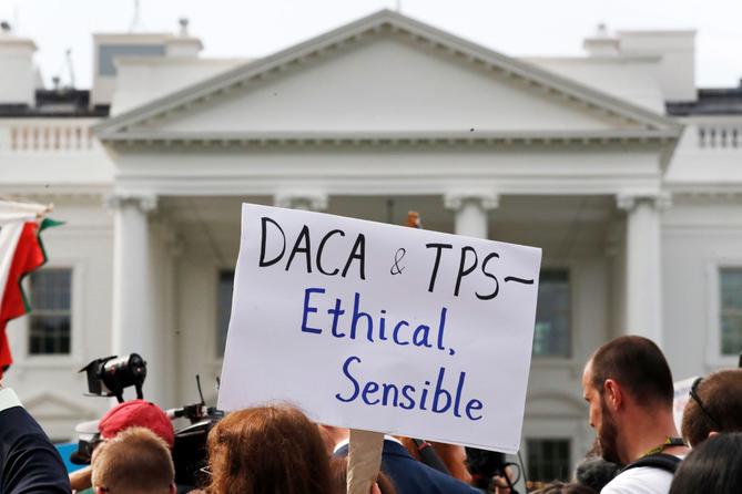 A person holds up a sign in support of the Deferred Action for Childhood Arrivals, known as DACA, and Temporary Protected Status programs during a rally at the White House, Sept. 5, 2017. A person holds up a sign in support of the Deferred Action for Childhood Arrivals, known as DACA, and Temporary Protected Status programs during a rally at the White House, Sept. 5, 2017.