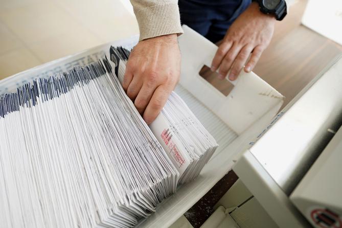 Mail ballots are sorted and counted by workers on Election Day in 2020.